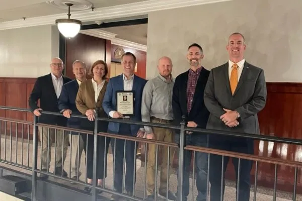 Ryan Sherman holds the plaque commemorating the 2023 Robert J. Dexter Memorial Award Lecture. He is with previous award winners, with the exception of Don White, who nominated Ryan and presented the award to him. Pictured from left to right are: Don White, Georgia Institute of Technology; Robert Connor, Purdue University (2005); Caroline Bennett, University of Kansas in Lawrence (2013); Ryan Sherman, Georgia Institute of Technology (2023); Matthew Hebdon, Virginia Polytechnic Institute and State University (2019, now with The University of Texas at Austin); Matthew Yarnold, Texas A&M University (2021, now with Auburn University) and William Collins, University of Kansas at Lawrence (2022). Photo by AISI. | Ryan Sherman Presents on Steel Additive Manufacturing for the 2023 Robert J. Dexter Memorial Award Lecture